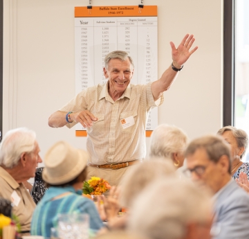 Man waves at 50 Plus club reunion